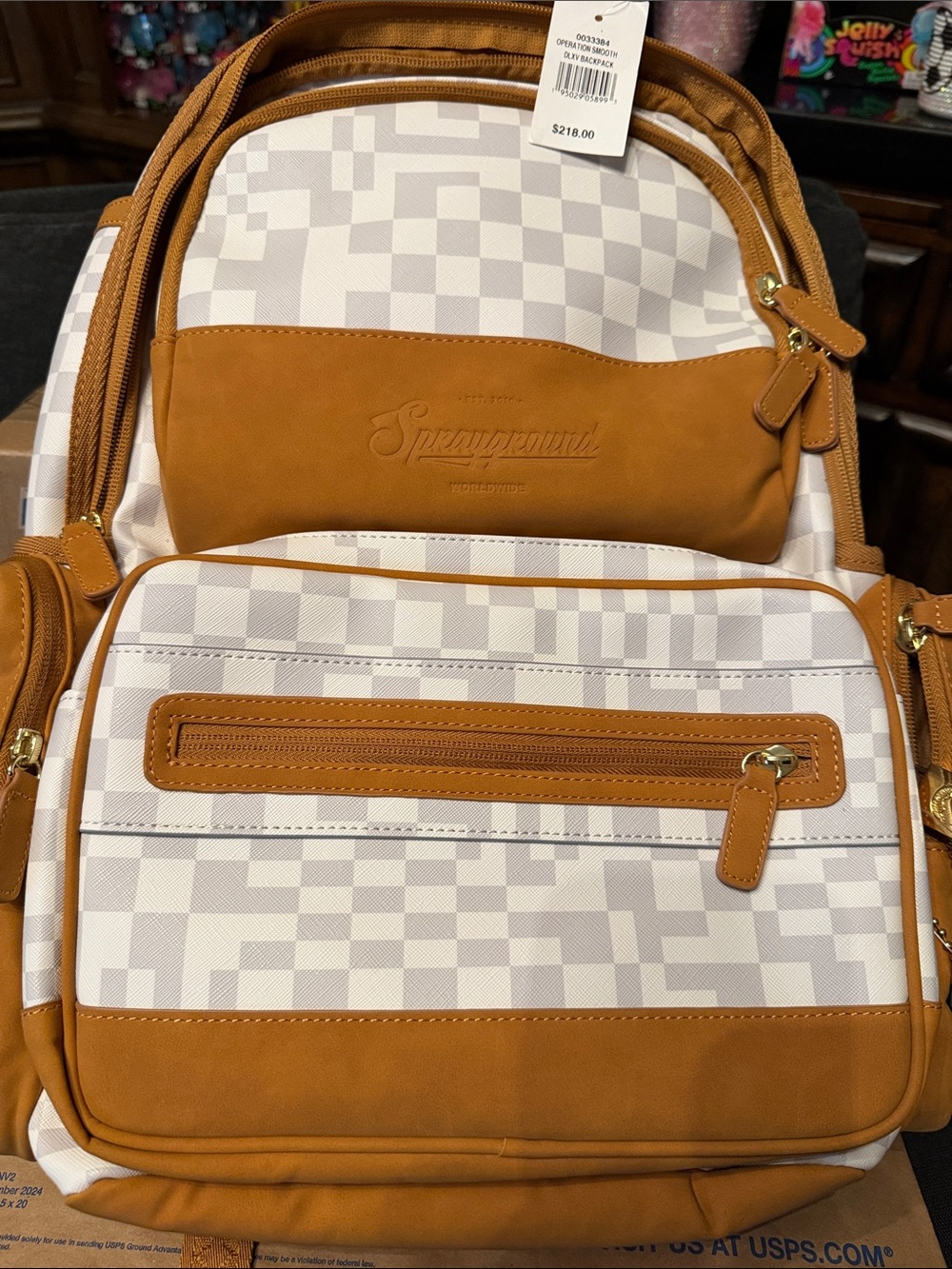 Sprayground White Checkered Backpack with Tan Accents and Gold Hardware